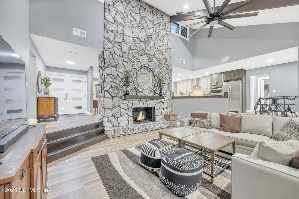 Fireplace, Interior, Kitchen, Living room, Recessed Lighting, Stainless Steel Appliances, Stone Walls, Wood Texture Flooring