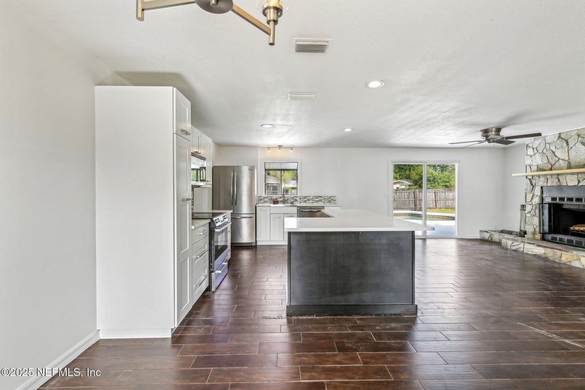 Fireplace, Interior, Kitchen, Recessed Lighting, Stainless Steel Appliances, Wood Texture Flooring