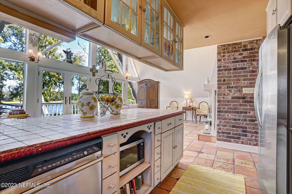 Interior, Kitchen, Recessed Lighting, Stainless Steel Appliances, Stone Walls, Tile Countertops