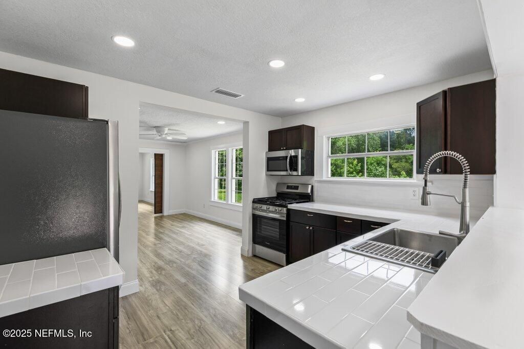 Interior, Kitchen, Recessed Lighting, Stainless Steel Appliances, Tile Countertops, Wood Texture Flooring