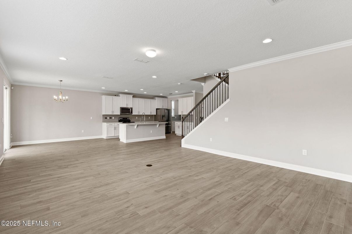 Chandelier, Empty room, Interior, Kitchen, Recessed Lighting, Stainless Steel Appliances, Wood Texture Flooring