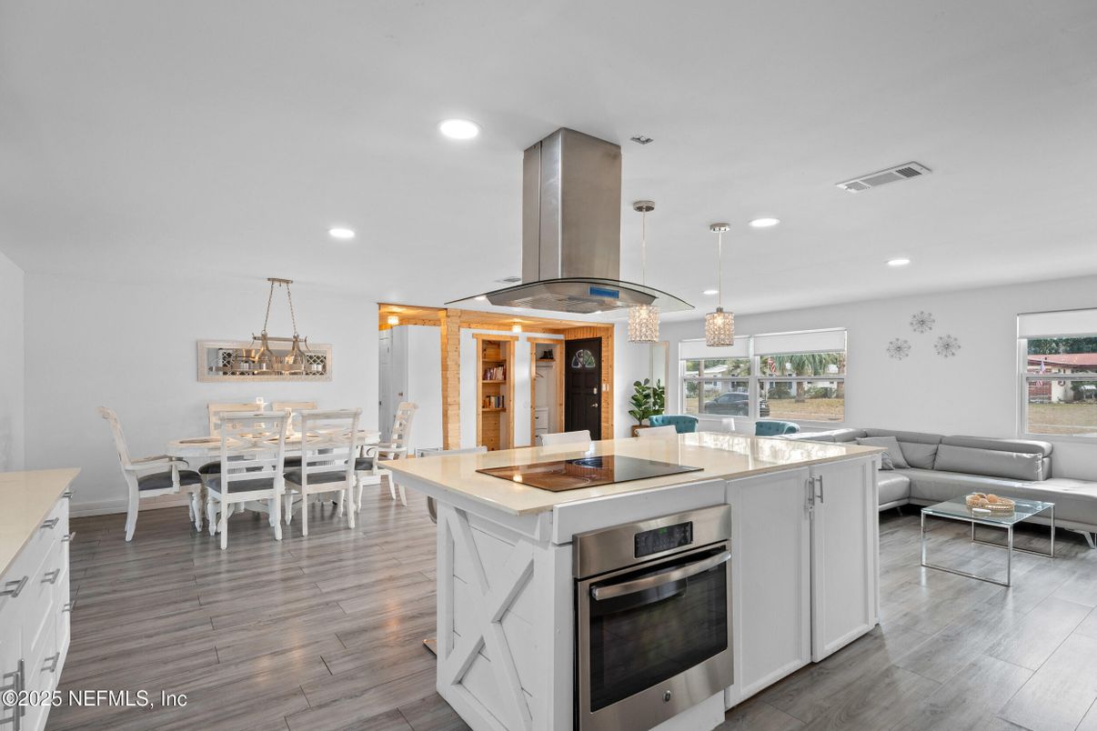 Chandelier, Dining room, Interior, Kitchen, Living room, Pendant Lights, Recessed Lighting, Stainless Steel Appliances, Wood Texture Flooring