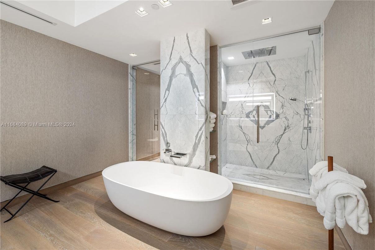 Bathroom, Free Standing Baths, Glass Shower, Interior, Marble Walls, Recessed Lighting, Wood Texture Flooring
