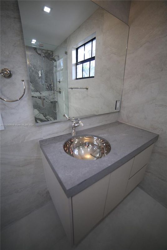 Bathroom, Dual Sink Vanities, Glass Shower, Interior, Marble Walls, Recessed Lighting