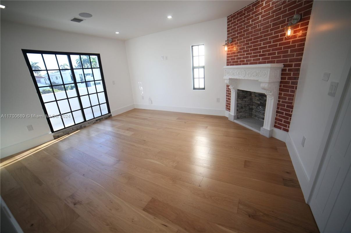 Empty room, Fireplace, Interior, Recessed Lighting, Stone Walls, Wood Texture Flooring