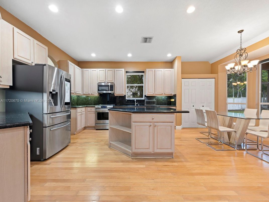Chandelier, Dining room, Interior, Kitchen, Recessed Lighting, Stainless Steel Appliances, Wood Texture Flooring