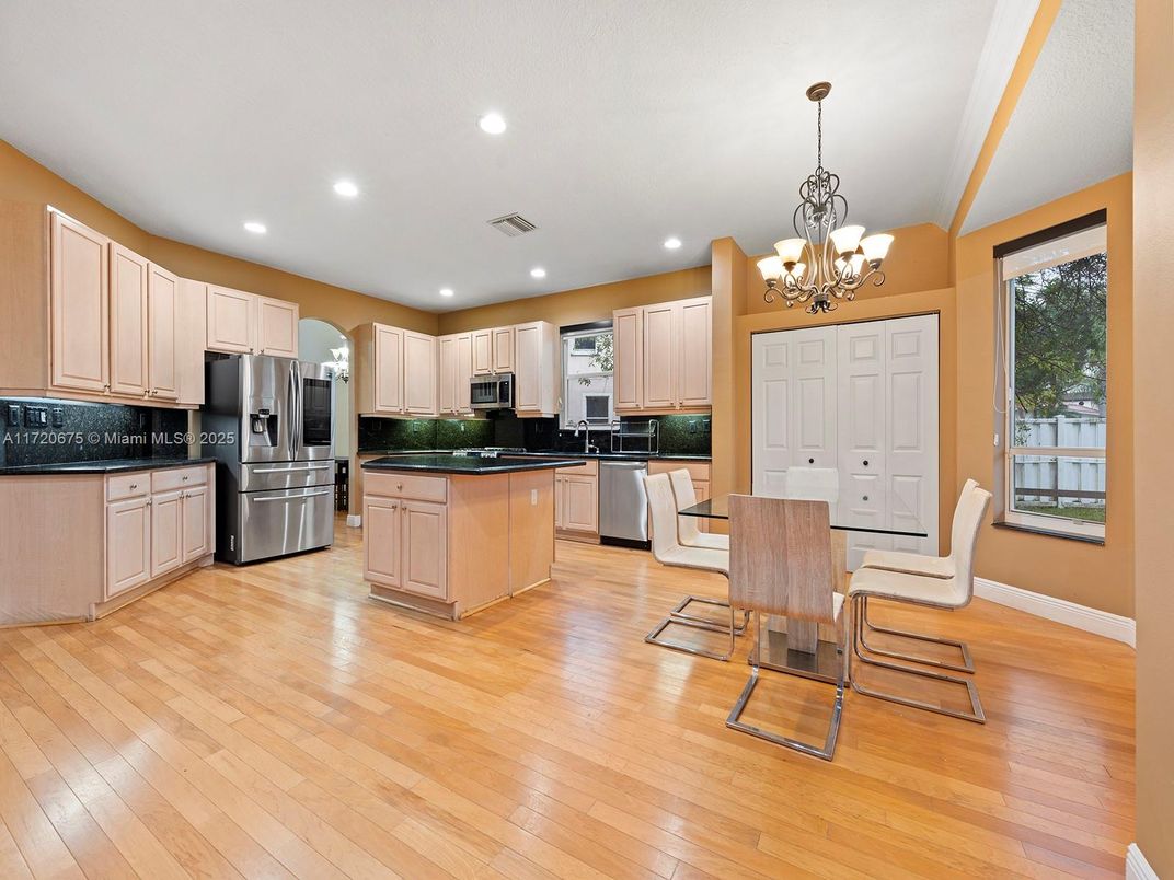Chandelier, Dining room, Interior, Kitchen, Recessed Lighting, Stainless Steel Appliances, Wood Texture Flooring