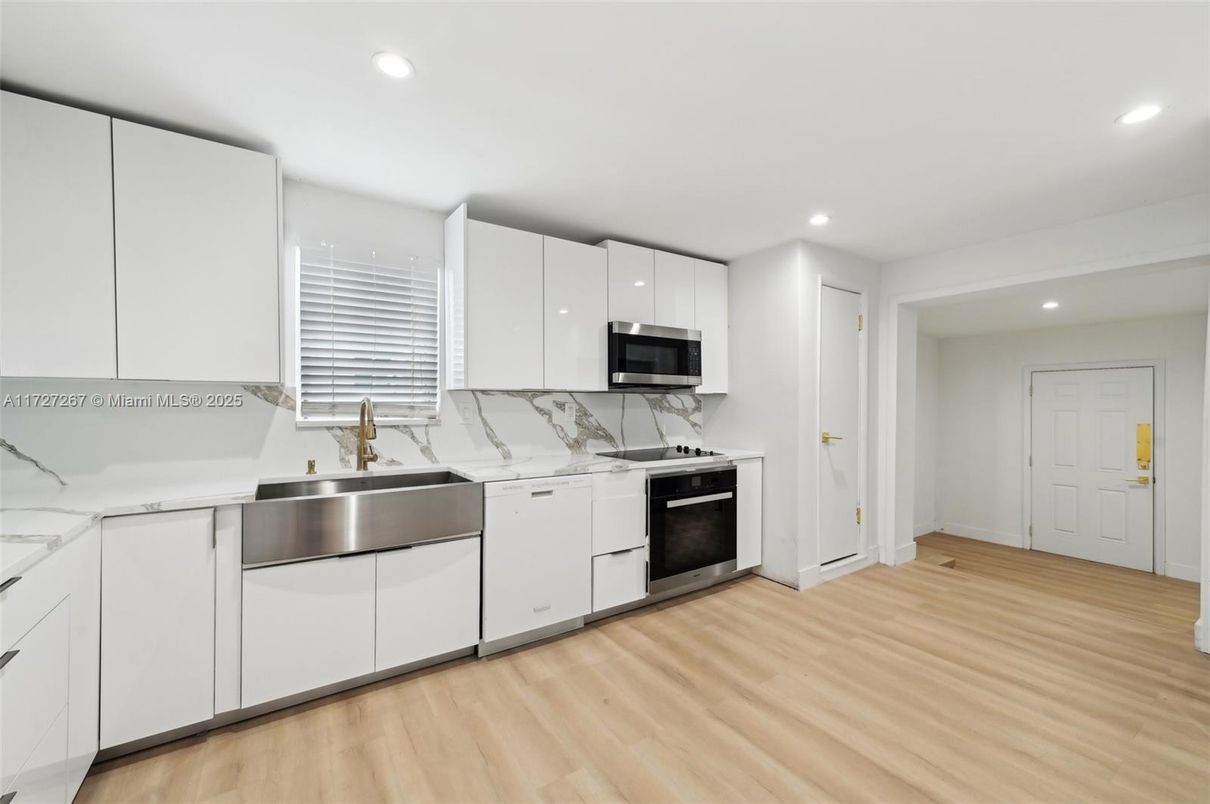 Interior, Kitchen, Marble Walls, Recessed Lighting, Stainless Steel Appliances, Wood Texture Flooring