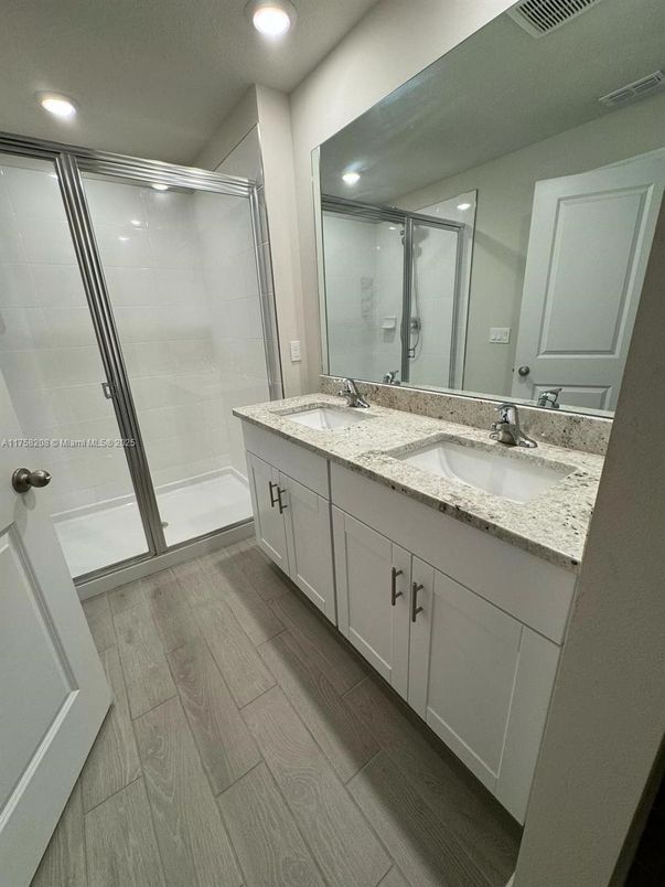 Bathroom, Dual Sink Vanities, Glass Shower, Interior, Recessed Lighting, Wood Texture Flooring