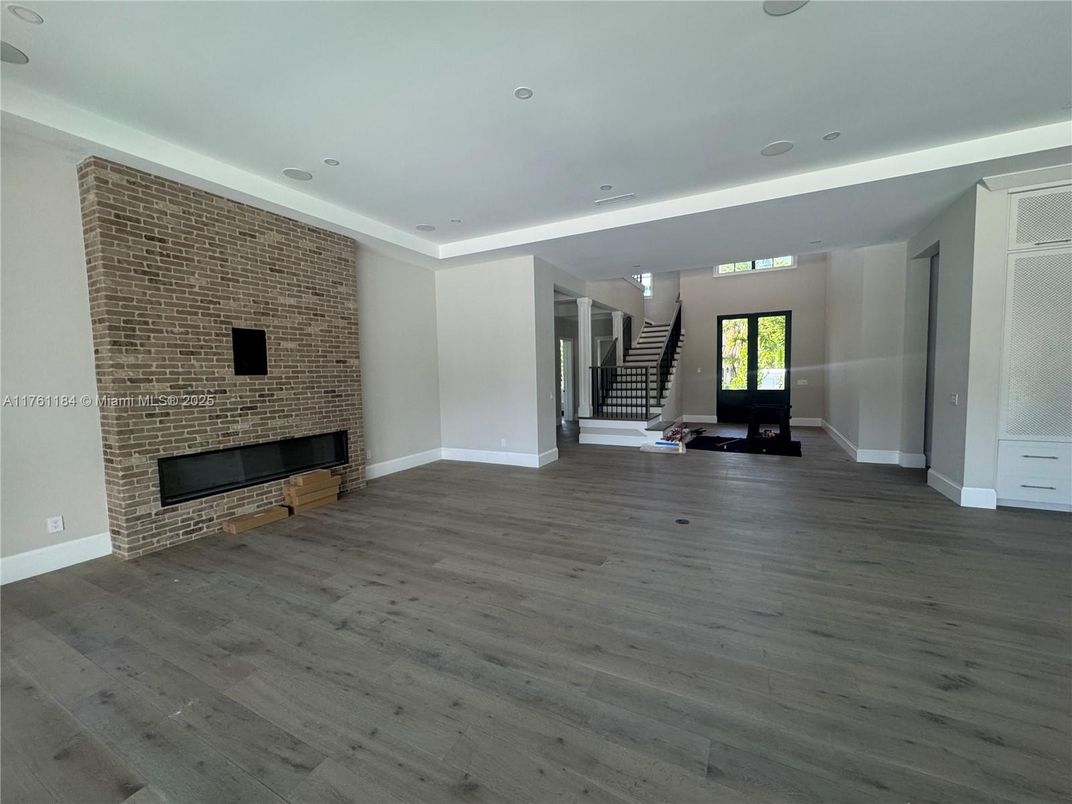 Empty room, Fireplace, Interior, Recessed Lighting, Stone Walls, Wood Texture Flooring