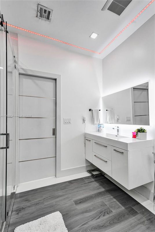 Bathroom, Dual Sink Vanities, Glass Shower, Interior, Recessed Lighting, Wood Texture Flooring