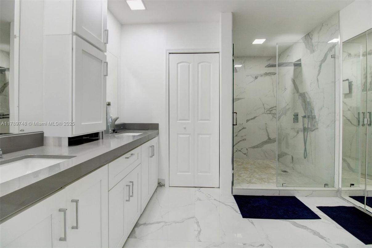 Bathroom, Dual Sink Vanities, Glass Shower, Interior, Marble, Marble Walls, Recessed Lighting