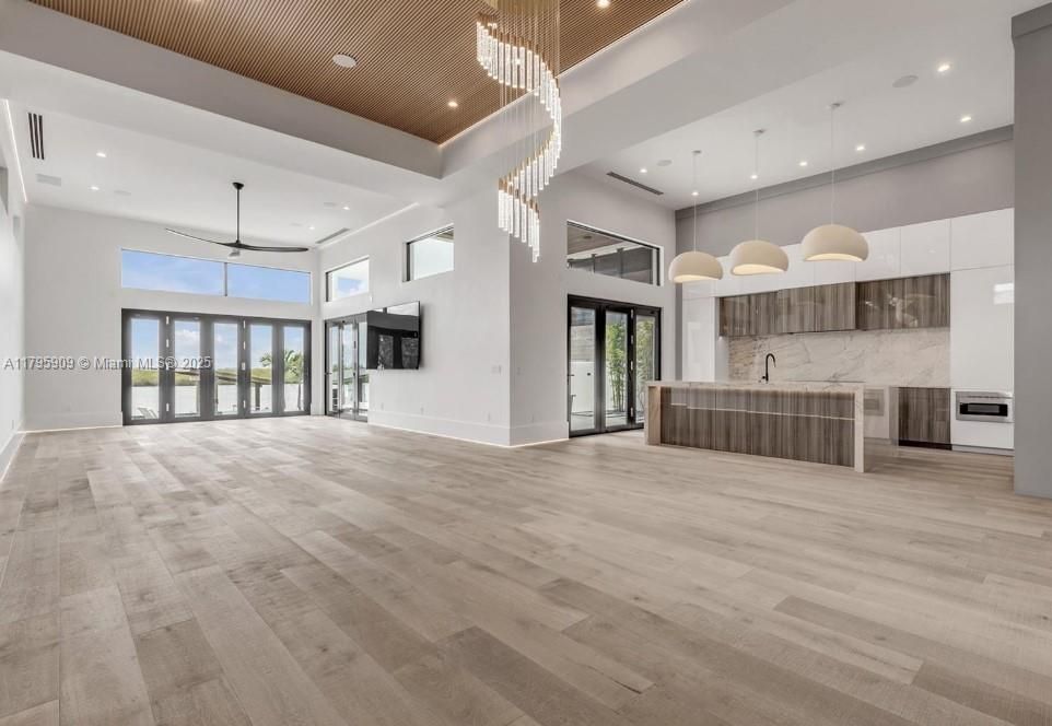 Chandelier, Interior, Kitchen, Pendant Lights, Recessed Lighting, Stainless Steel Appliances, Wood Texture Flooring