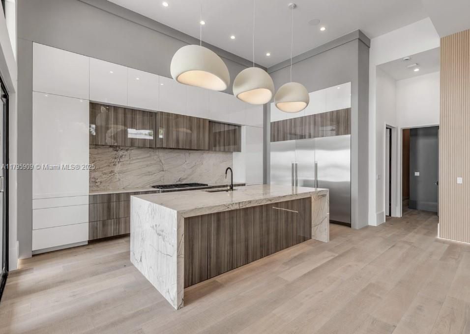 Interior, Kitchen, Marble Walls, Pendant Lights, Recessed Lighting, Stainless Steel Appliances, Wood Texture Flooring