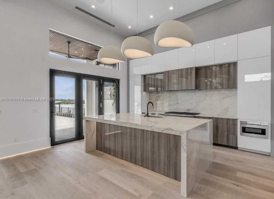 Interior, Kitchen, Marble Walls, Recessed Lighting, Stainless Steel Appliances, Wood Texture Flooring