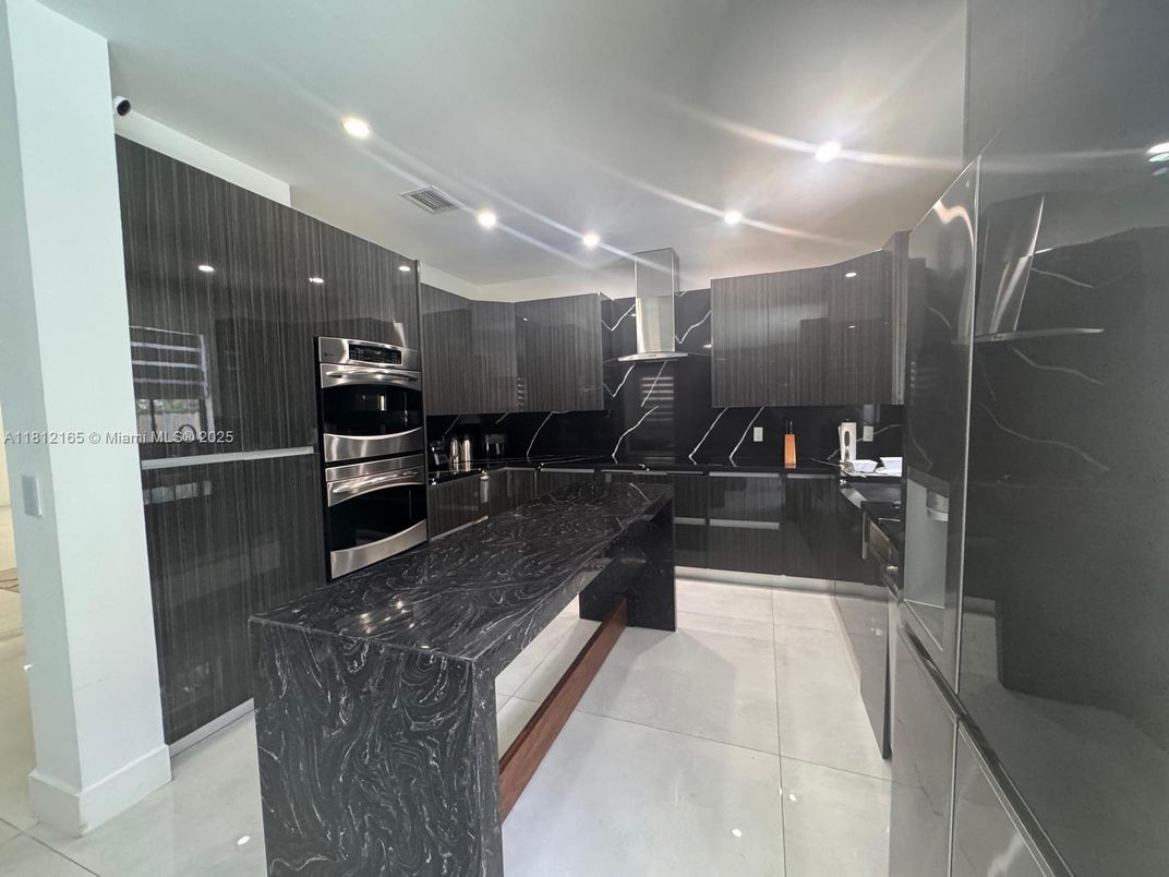 Interior, Kitchen, Marble Walls, Recessed Lighting, Stainless Steel Appliances