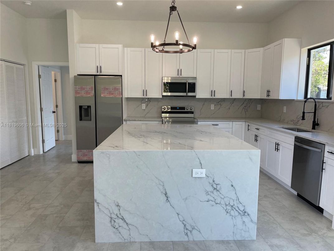 Interior, Kitchen, Marble Walls, Pendant Lights, Recessed Lighting, Stainless Steel Appliances