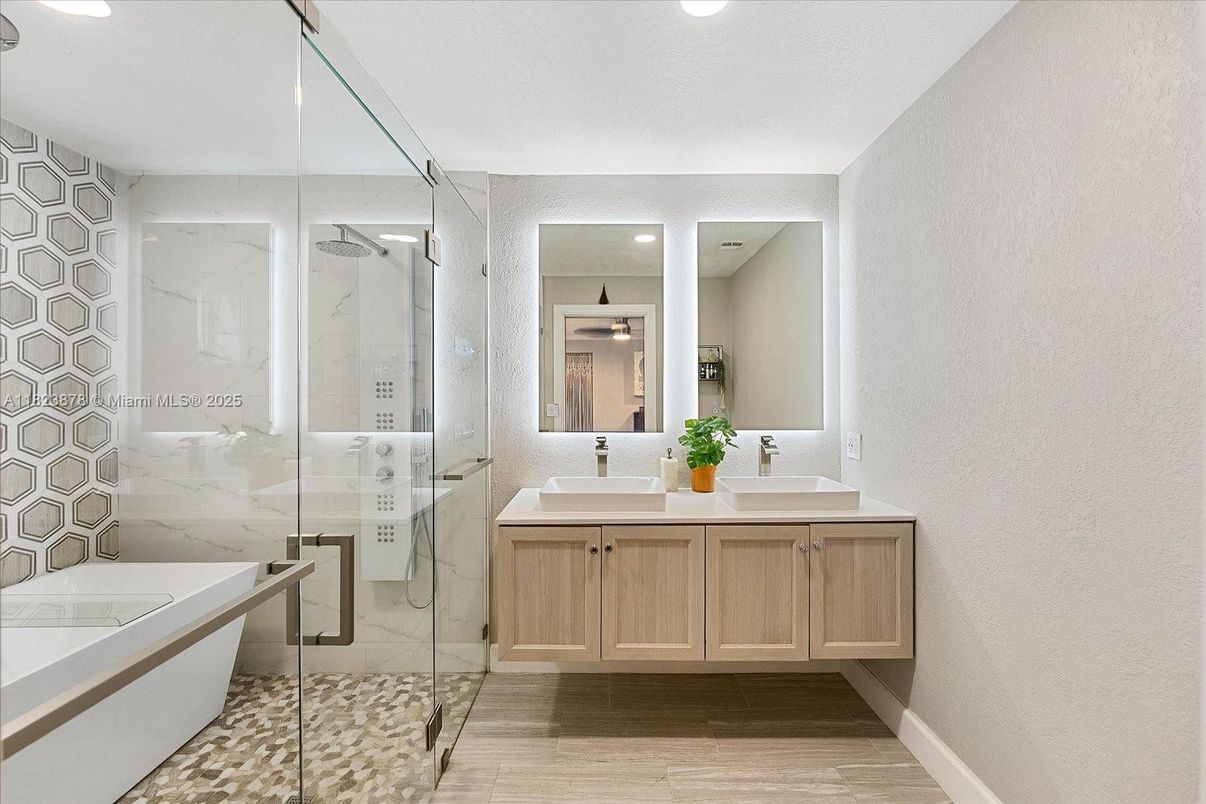 Bathroom, Dual Sink Vanities, Glass Shower, Interior, Marble Walls, Recessed Lighting, Wood Texture Flooring