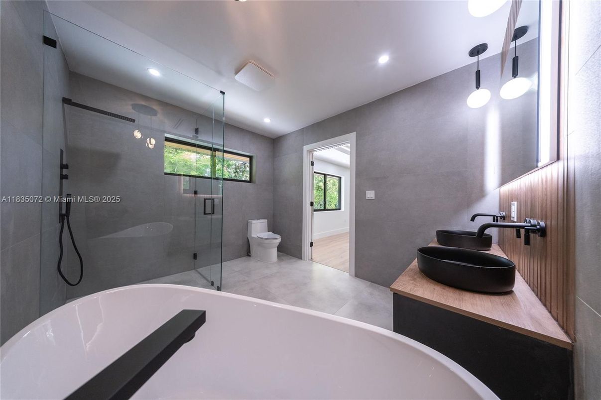 Bathroom, Dual Sink Vanities, Free Standing Baths, Glass Shower, Interior, Pendant Lights, Recessed Lighting, Wood Texture Flooring