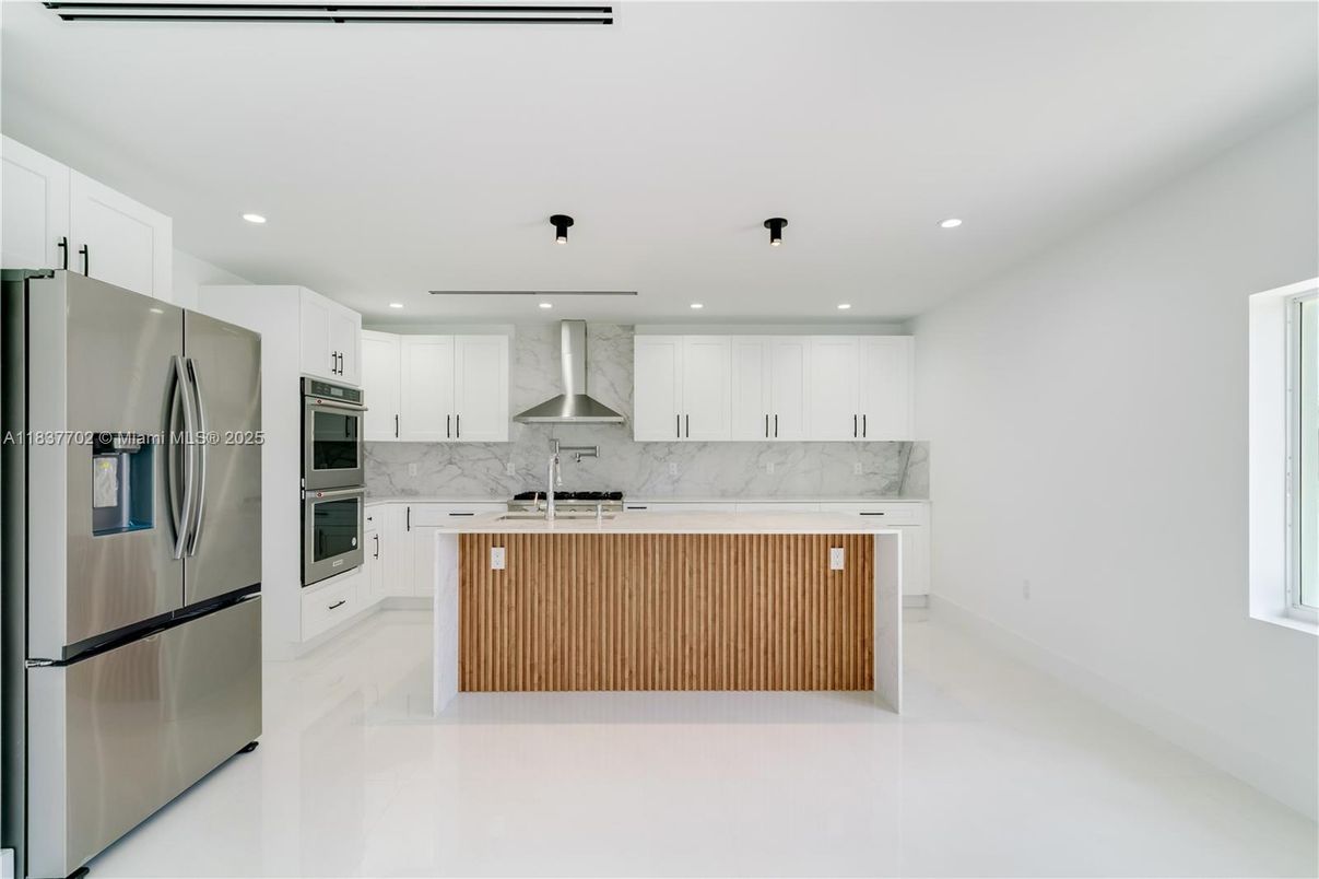 Interior, Kitchen, Marble Walls, Recessed Lighting, Stainless Steel Appliances