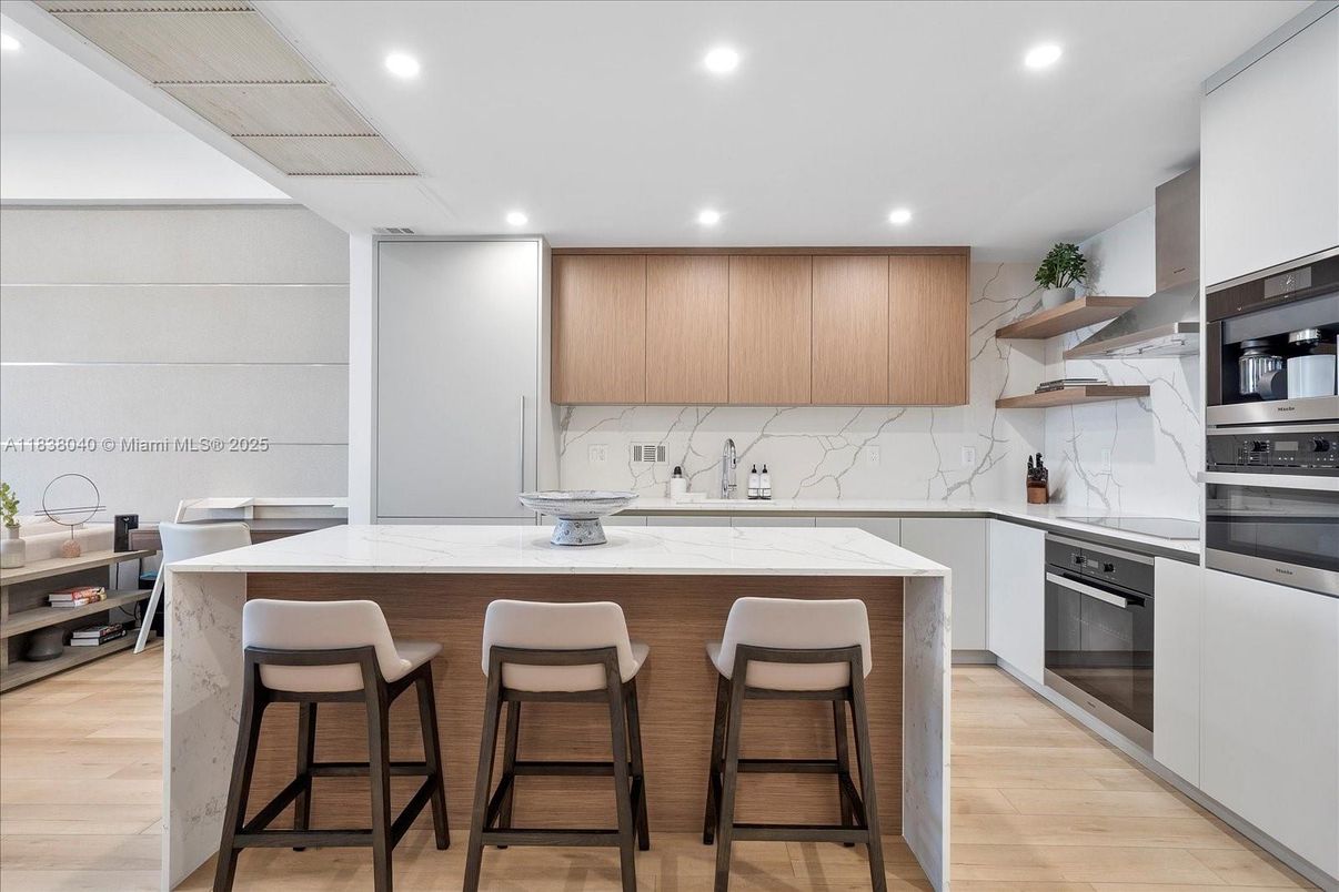 Interior, Kitchen, Marble Walls, Recessed Lighting, Stainless Steel Appliances, Wood Texture Flooring