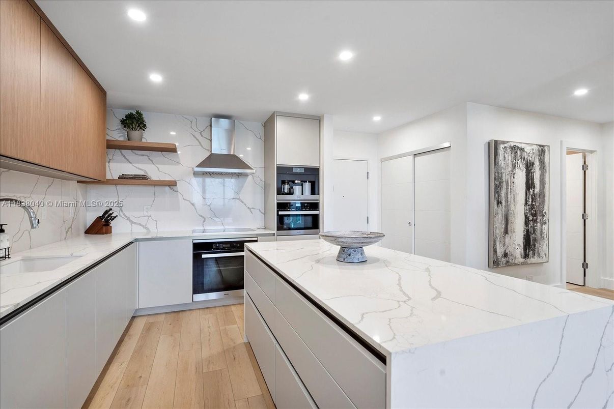 Interior, Kitchen, Marble Walls, Recessed Lighting, Stainless Steel Appliances, Wood Texture Flooring