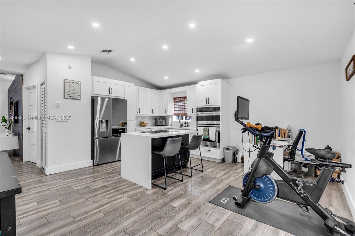 Fitness Equipment, Interior, Kitchen, Recessed Lighting, Stainless Steel Appliances, Wood Texture Flooring