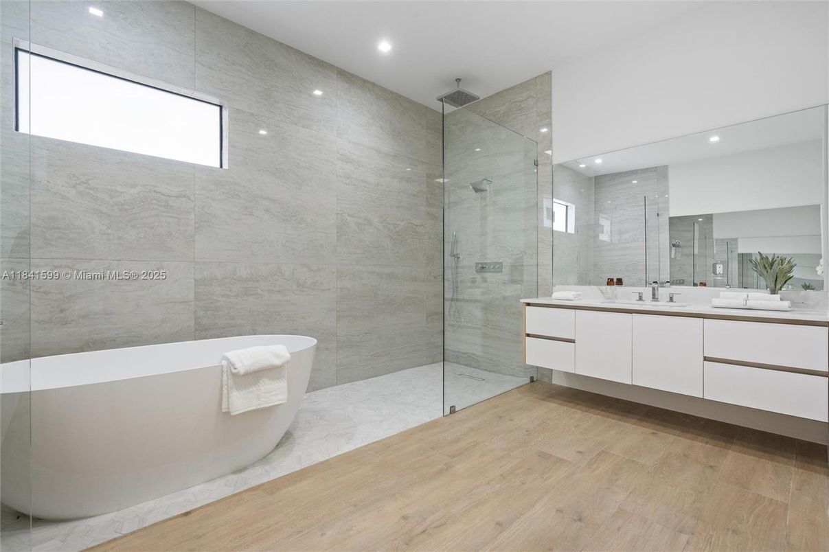 Bathroom, Free Standing Baths, Glass Shower, Interior, Marble Walls, Recessed Lighting, Wood Texture Flooring