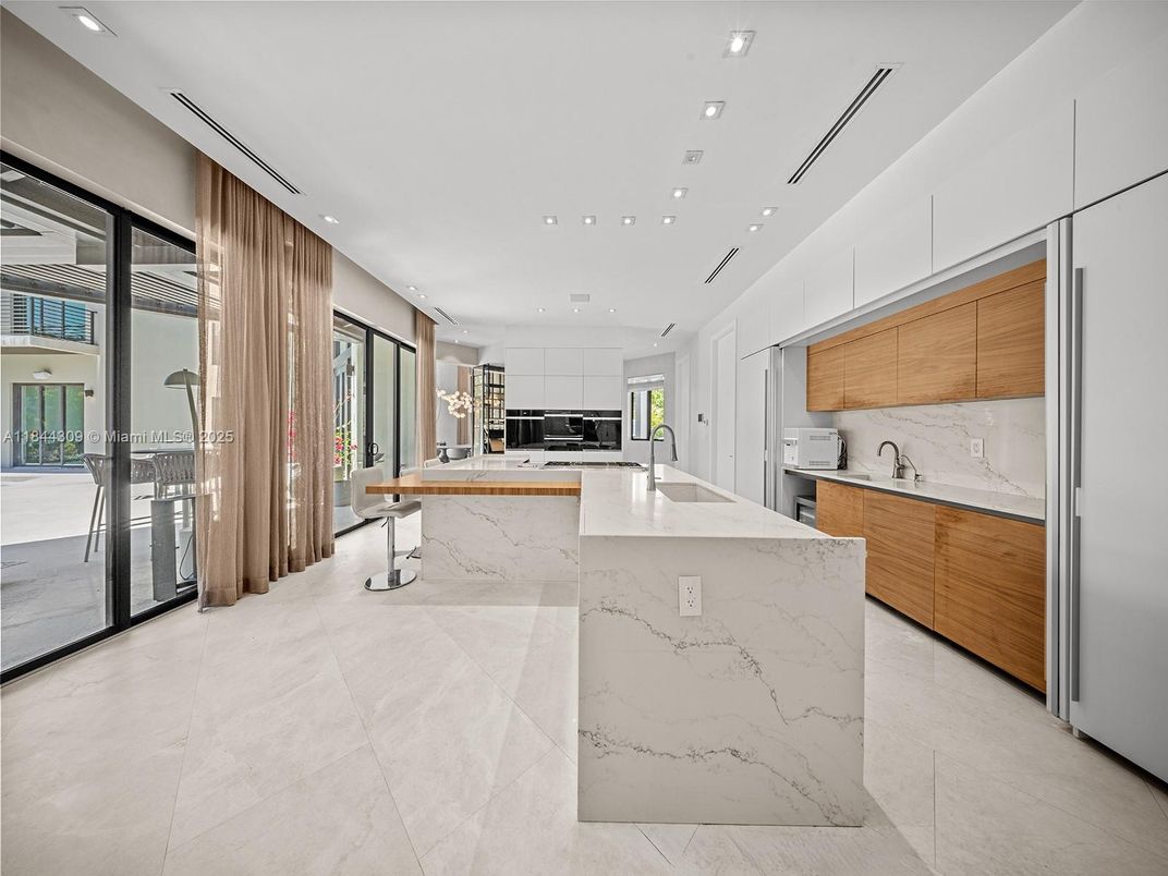 Interior, Kitchen, Marble Walls, Recessed Lighting, Stainless Steel Appliances
