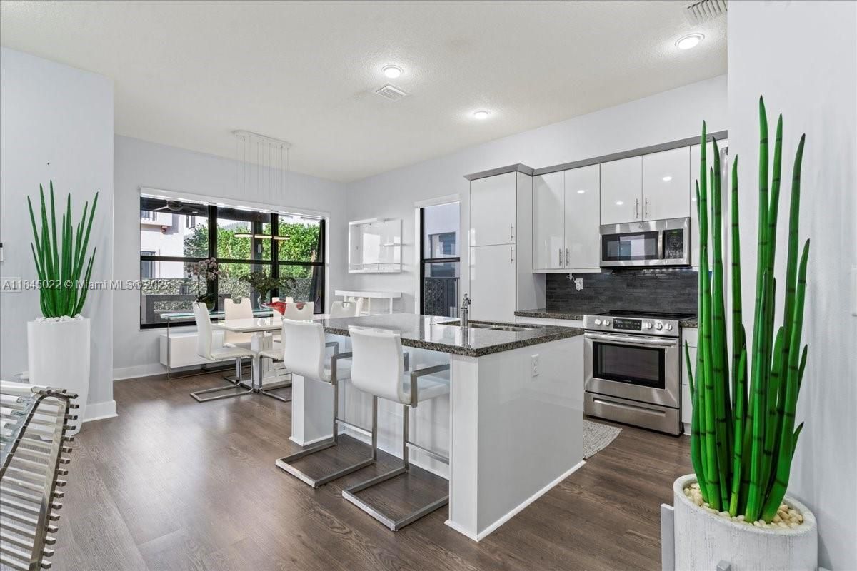 Dining room, Interior, Kitchen, Pendant Lights, Recessed Lighting, Stainless Steel Appliances, Wood Texture Flooring