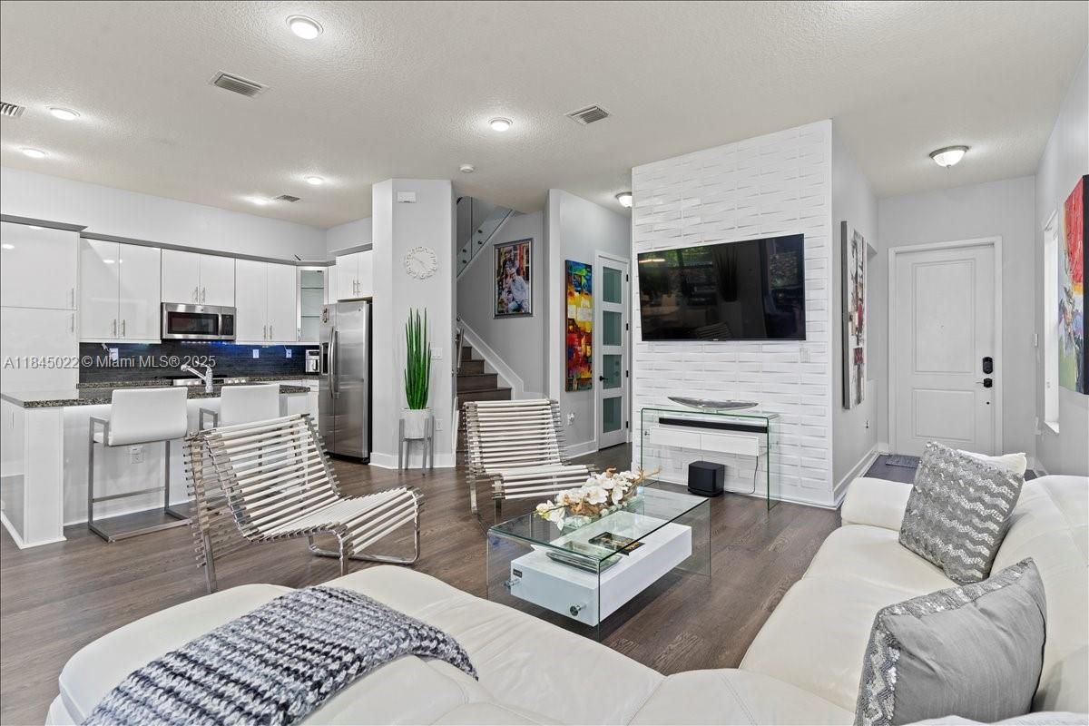 Fireplace, Interior, Kitchen, Living room, Recessed Lighting, Stainless Steel Appliances, Wood Texture Flooring
