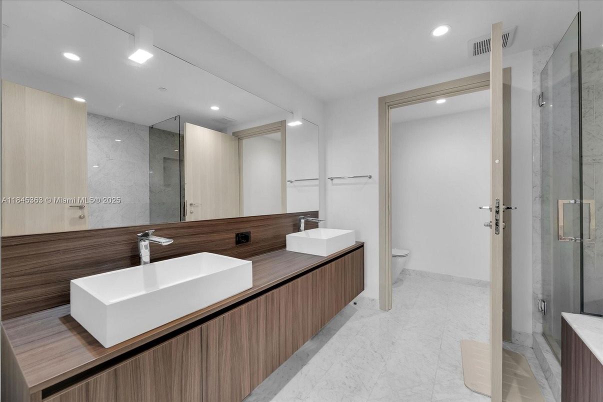 Bathroom, Dual Sink Vanities, Glass Shower, Interior, Marble, Marble Walls, Recessed Lighting