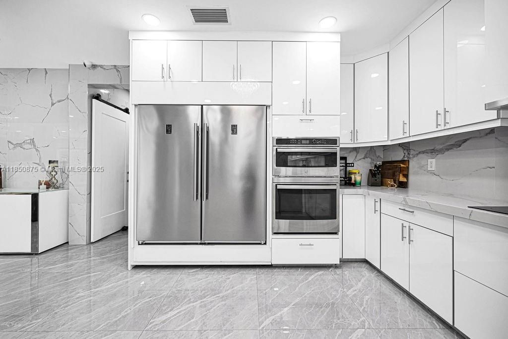Interior, Kitchen, Marble Walls, Recessed Lighting, Stainless Steel Appliances