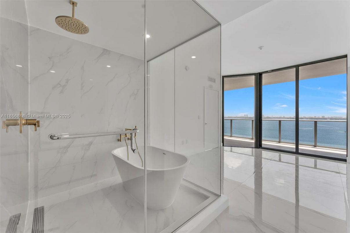 Bathroom, Free Standing Baths, Glass Shower, Interior, Marble, Marble Walls, Recessed Lighting, Water