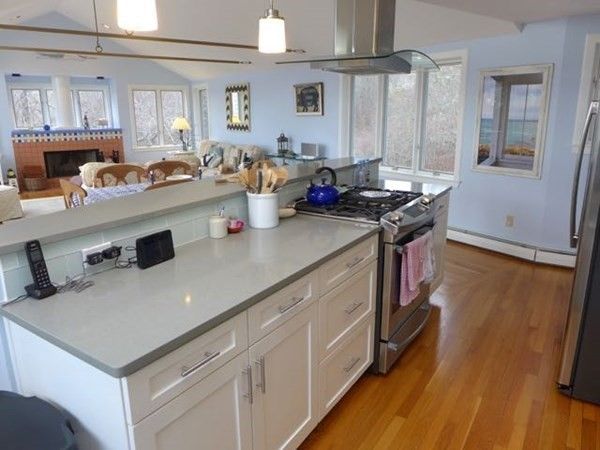 Fireplace, Interior, Kitchen, Living room, Pendant Lights, Stainless Steel Appliances, Wood Texture Flooring