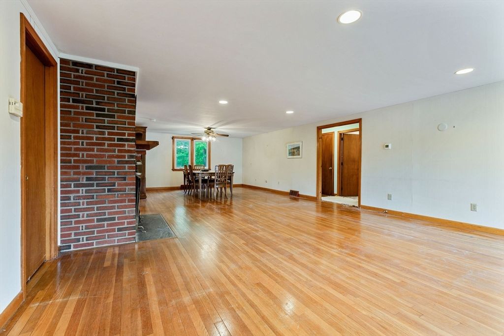 Dining room, Empty room, Fireplace, Interior, Recessed Lighting, Stone Walls, Wood Texture Flooring