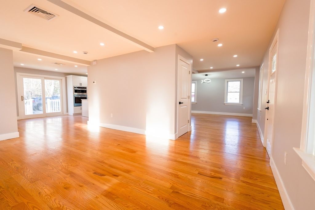 Empty room, Interior, Kitchen, Recessed Lighting, Stainless Steel Appliances, Wood Texture Flooring