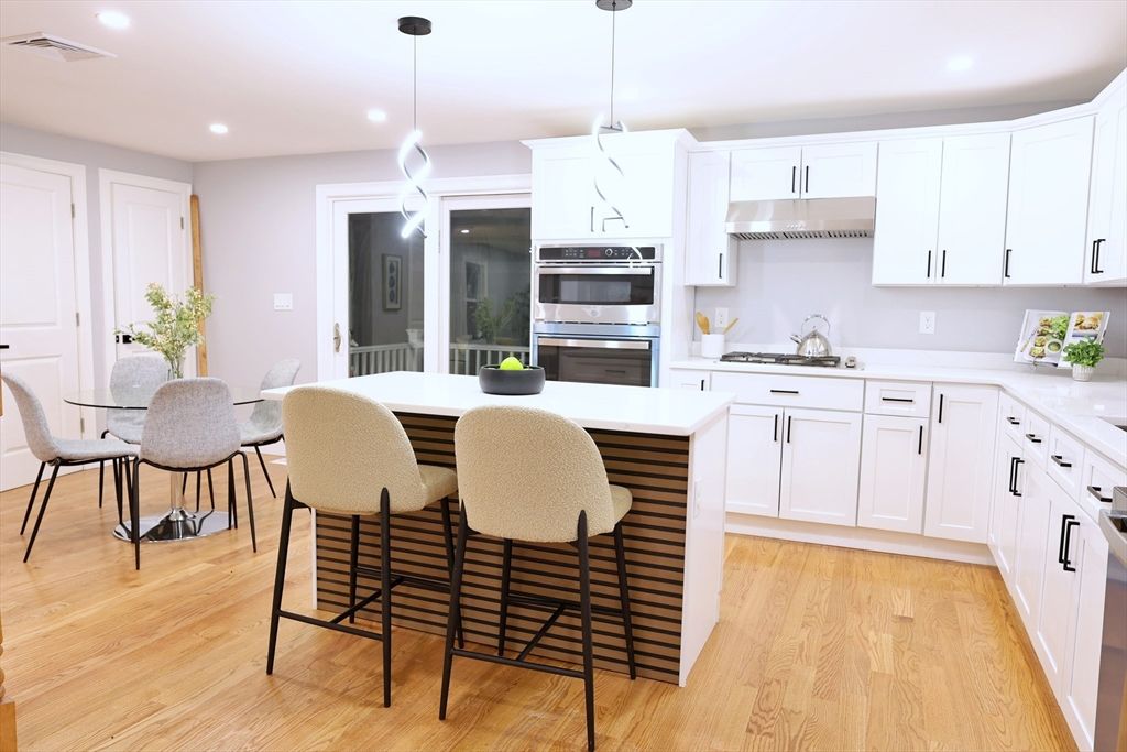 Dining room, Interior, Kitchen, Pendant Lights, Recessed Lighting, Stainless Steel Appliances, Wood Texture Flooring