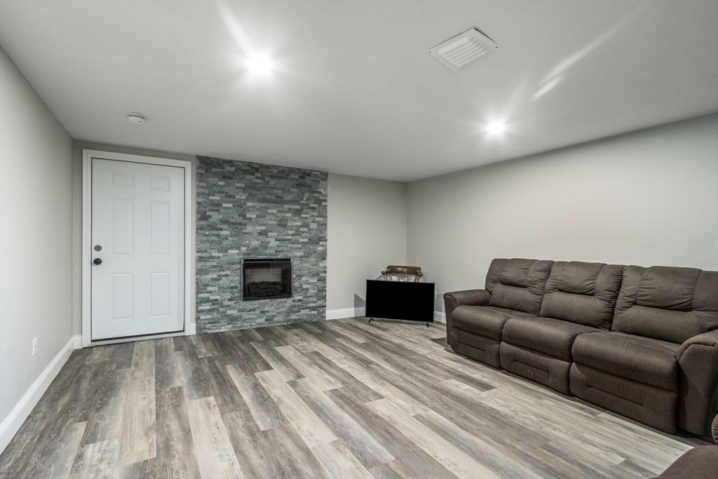 Fireplace, Interior, Living room, Recessed Lighting, Stone Walls, Wood Texture Flooring