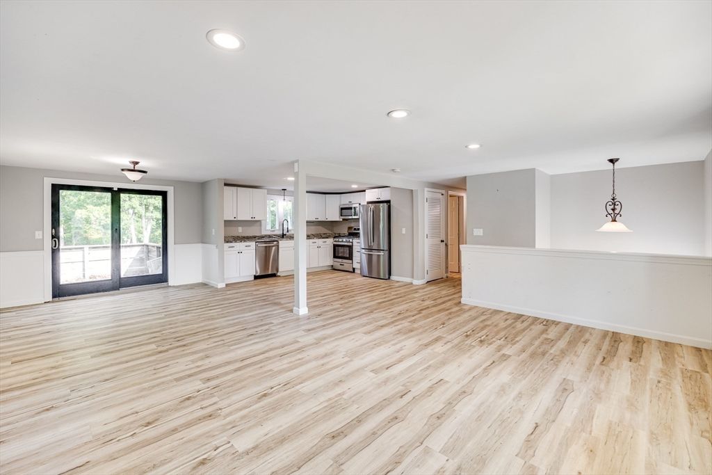 Empty room, Interior, Kitchen, Pendant Lights, Recessed Lighting, Stainless Steel Appliances, Wood Texture Flooring