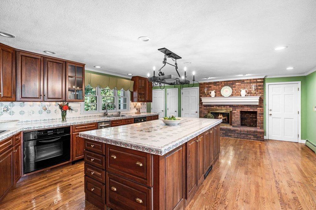 Chandelier, Fireplace, Interior, Kitchen, Pendant Lights, Recessed Lighting, Stone Walls, Wood Texture Flooring