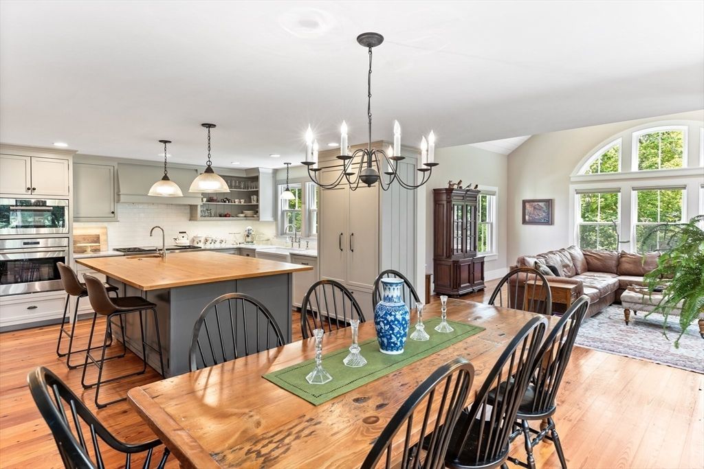 Chandelier, Dining room, Interior, Kitchen, Living room, Pendant Lights, Recessed Lighting, Stainless Steel Appliances, Wood Texture Flooring