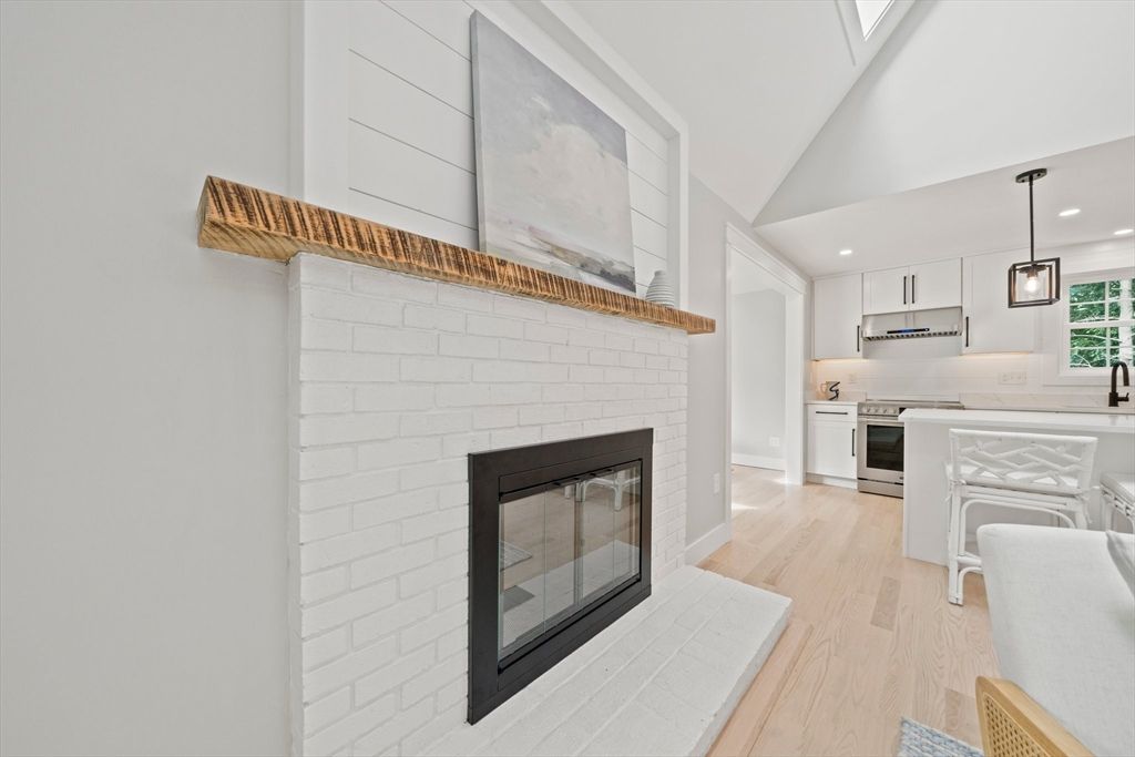 Fireplace, Interior, Kitchen, Pendant Lights, Recessed Lighting, Stainless Steel Appliances, Stone Walls, Wood Texture Flooring