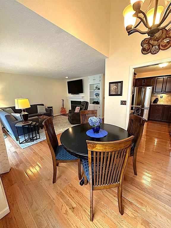 Chandelier, Dining room, Interior, Kitchen, Living room, Stainless Steel Appliances, Wood Texture Flooring
