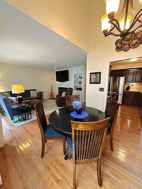 Chandelier, Dining room, Interior, Kitchen, Living room, Stainless Steel Appliances, Wood Texture Flooring
