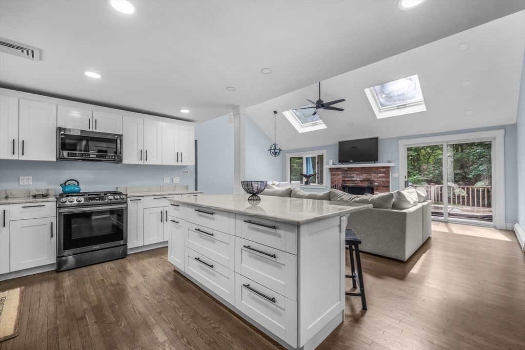 Fireplace, Interior, Kitchen, Living room, Pendant Lights, Recessed Lighting, Stainless Steel Appliances, Wood Texture Flooring