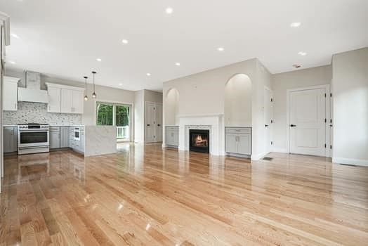 Empty room, Fireplace, Interior, Kitchen, Pendant Lights, Recessed Lighting, Stainless Steel Appliances, Wood Texture Flooring