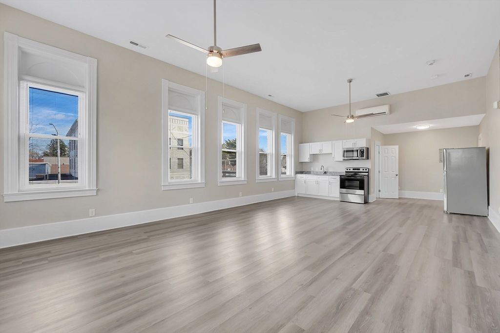 Empty room, Interior, Kitchen, Recessed Lighting, Stainless Steel Appliances, Wood Texture Flooring