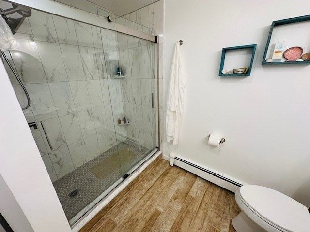 Bathroom, Glass Shower, Interior, Marble Walls, Wood Texture Flooring