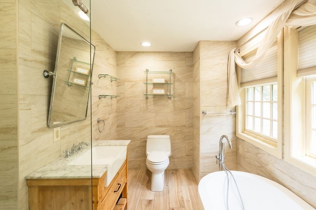 Bathroom, Dual Sink Vanities, Glass Shower, Interior, Marble Walls, Recessed Lighting, Wood Texture Flooring